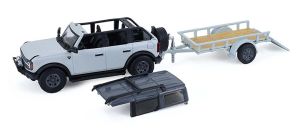 GREEN32330-D - 2021 Ford Bronco 4-door Cactus Green with flatbed trailer and motorcycle from the Hitch & Tow series, still in its original packaging.