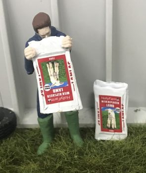 WM078F - Farmer emptying a bag of milk powder for lambs