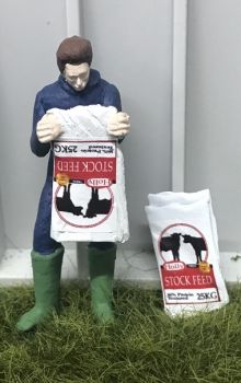 WM078G - Farmer emptying a bag of cow food