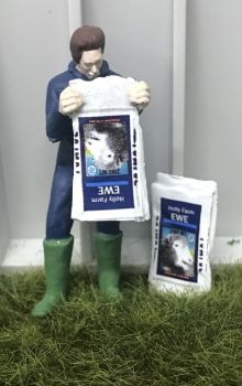 WM078H - Farmer emptying a bag of sheep food