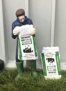 WM078J - Farmer emptying a bag of horse food